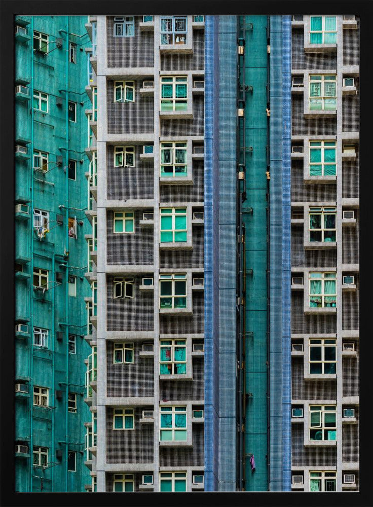 A striking close-up of two densely packed apartment buildings, one with a teal tiled facade and the other with a grey and blue tiled facade, creating a strong pattern of repeating windows and geometric lines. Decor
