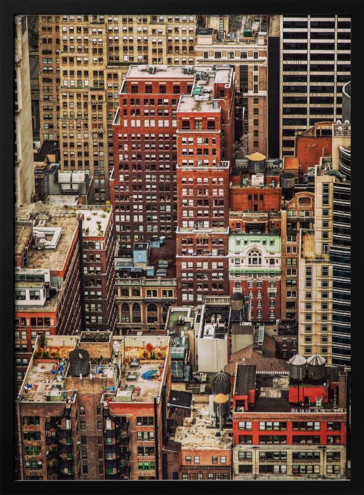 A high-angle, telephoto view of a dense cluster of New York City buildings, featuring a mix of red and brown brick architecture, with numerous windows creating a geometric pattern and several classic wooden water towers perched on the rooftops. Print