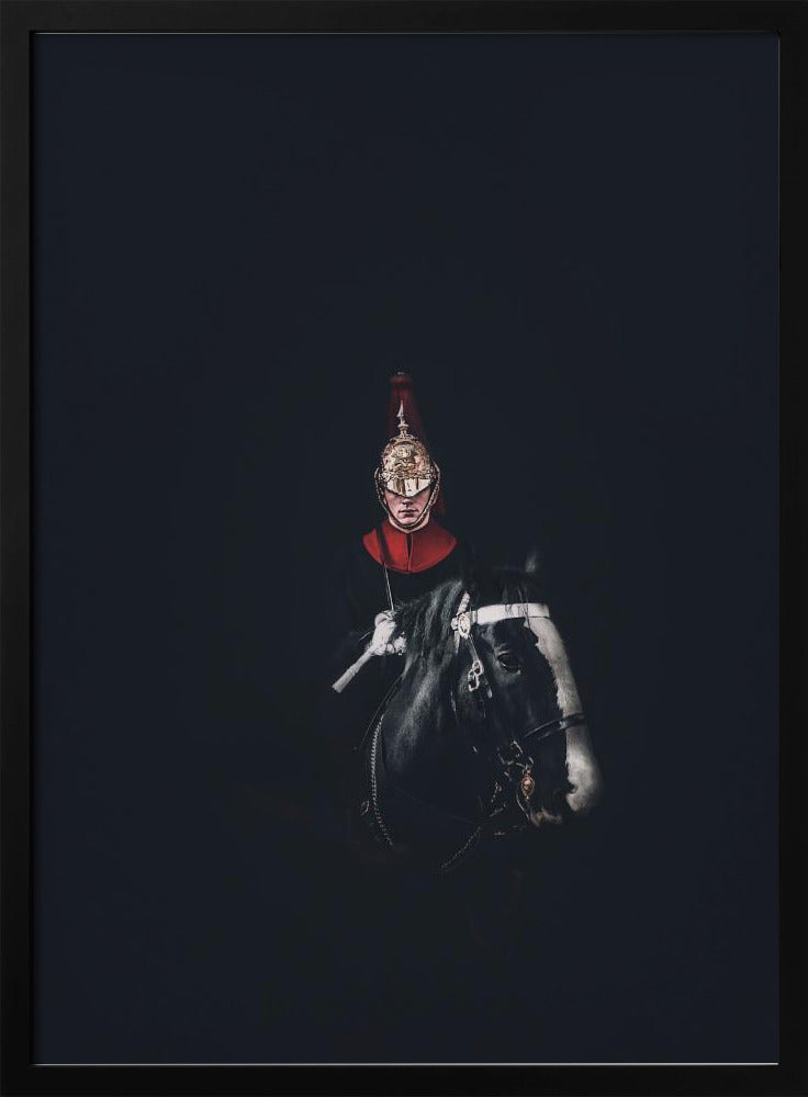 A dramatic portrait of a British Royal Guard on a black horse, emerging from a completely black background. The guard is wearing a traditional uniform with a red collar and a shiny gold helmet with a red plume. Poster