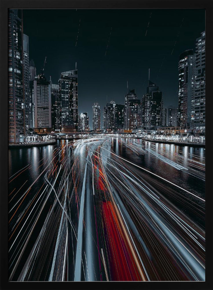 A dynamic long-exposure photograph of a bustling city marina at night. In the foreground, vibrant streaks of red and white light from moving boats cut across the dark water. In the background, a modern skyline of illuminated skyscrapers stands against a dark night sky, creating a futuristic and energetic scene. Poster