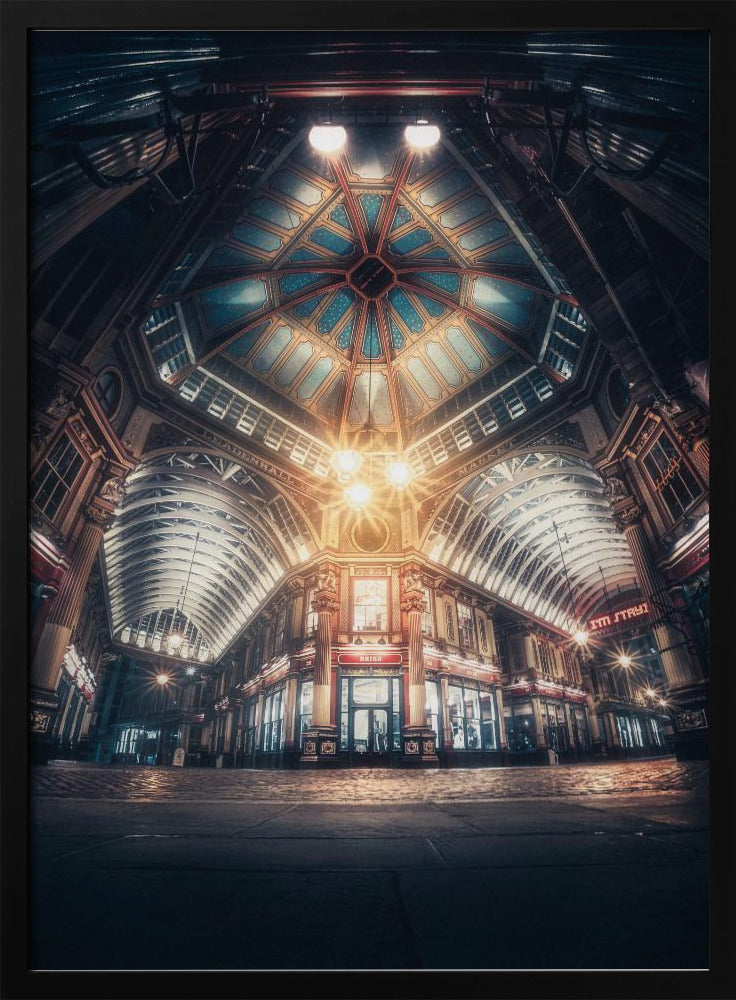 A dramatic, low-angle, wide shot of an empty Leadenhall Market at night. The ornate, domed ceiling is illuminated in blue and gold by bright, warm lights, which also cast a glow on the cobblestone floor and detailed Victorian storefronts. Wall Art