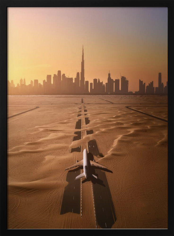 A surreal high-angle view of a white airplane on a runway partially buried in desert sand, pointing towards the Dubai city skyline during a hazy orange sunset. Decor