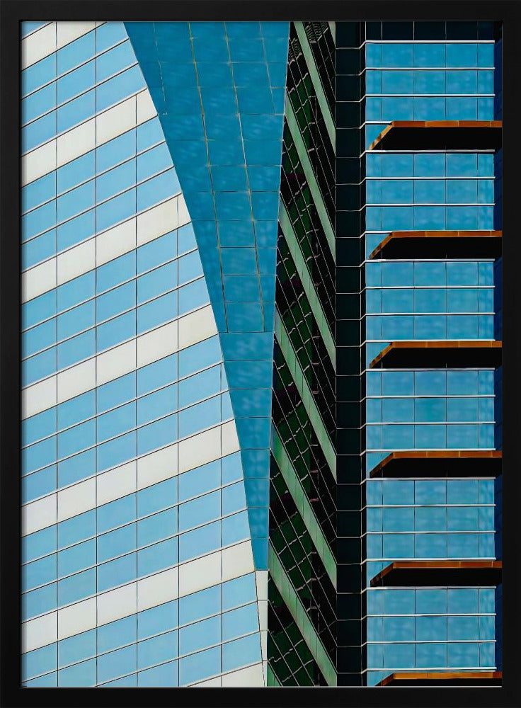 An abstract close-up photograph of modern skyscrapers, featuring a dynamic composition of intersecting lines and geometric patterns. The facades consist of blue, white, and dark green reflective glass, creating a visually complex play of light, shadow, and color. Wall Art