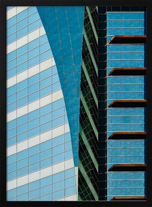 An abstract close-up photograph of modern skyscrapers, featuring a dynamic composition of intersecting lines and geometric patterns. The facades consist of blue, white, and dark green reflective glass, creating a visually complex play of light, shadow, and color. Wall Art