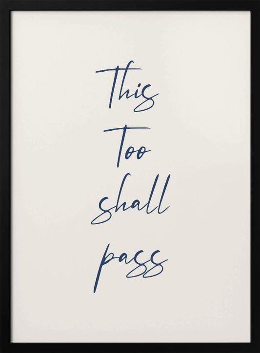 A framed art print featuring the inspirational quote 'This Too shall pass' in a dark blue, elegant cursive script against a simple cream background. The piece is bordered by a thin black frame. Poster