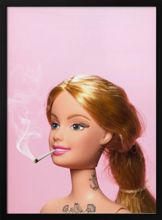A close-up photograph of a blonde doll, resembling Barbie, with tattoos on her neck and chest, smoking a joint against a solid pink background. Smoke curls upwards from the lit cigarette in her pink-lipsticked mouth. Artwork
