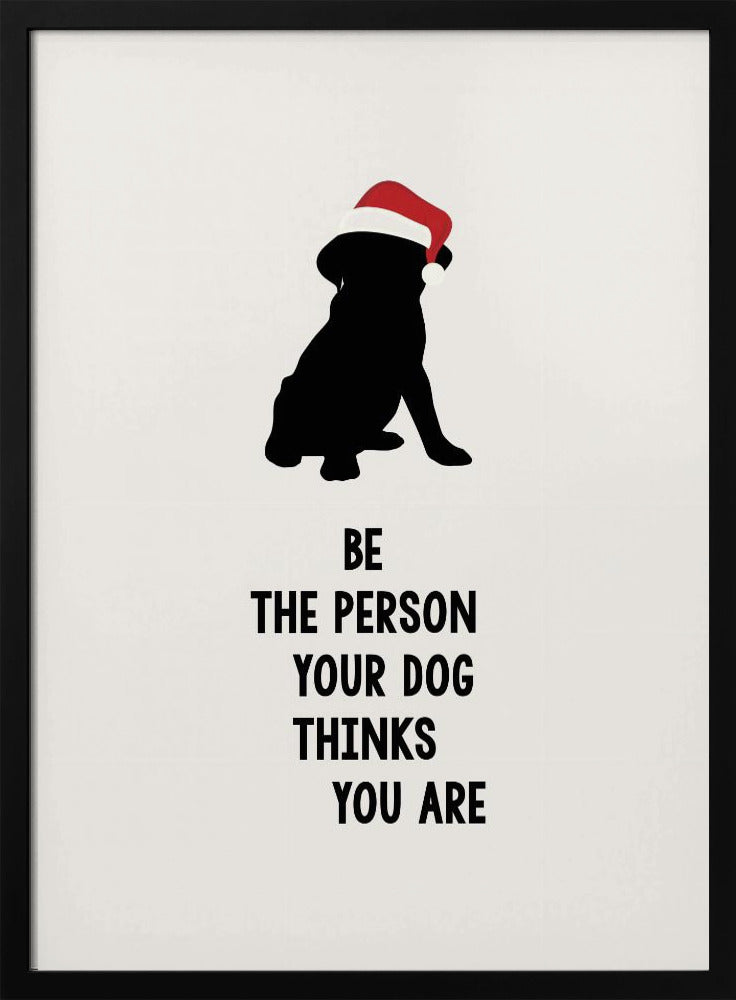 A framed art print featuring a black silhouette of a dog wearing a red Santa hat on an off-white background. Below the dog is the motivational quote, 'BE THE PERSON YOUR DOG THINKS YOU ARE' in black block letters. Decor