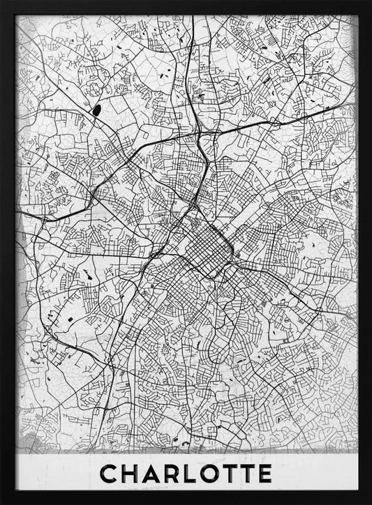 A minimalist black and white map of Charlotte, North Carolina, displayed in a black frame. The map details the intricate network of city streets and highways. At the bottom, a white banner features the city's name 'CHARLOTTE' in a bold, black, sans-serif font. Poster