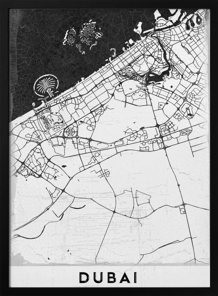 A minimalist black and white map of Dubai in a black frame. The water is depicted in black with a subtle texture, while the land is white, showing the city's road network in thin black lines. Key features like the Palm Jumeirah and The World Islands are visible off the coast. The word 'DUBAI' is written in a bold, black, sans-serif font at the bottom. Decor
