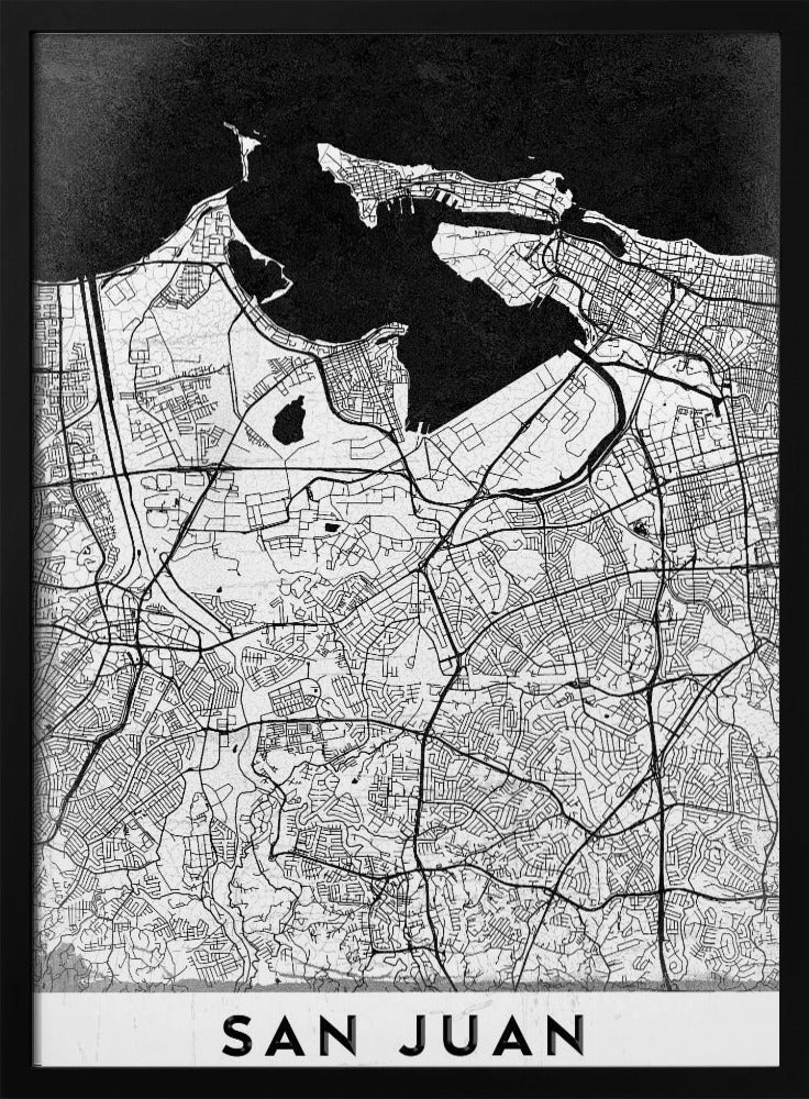 A minimalist black and white map of San Juan, Puerto Rico, shown as a framed poster. The land is depicted in white with intricate black lines for roads and streets, while the surrounding water is a solid, textured black. A white banner at the bottom features the text 'SAN JUAN' in a bold, black, sans-serif font. Artwork