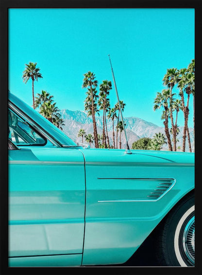A vibrant, stylized photograph of a vintage turquoise car parked under a clear blue sky, with a row of tall palm trees and distant mountains creating a classic, sunny California scene. Wall Art