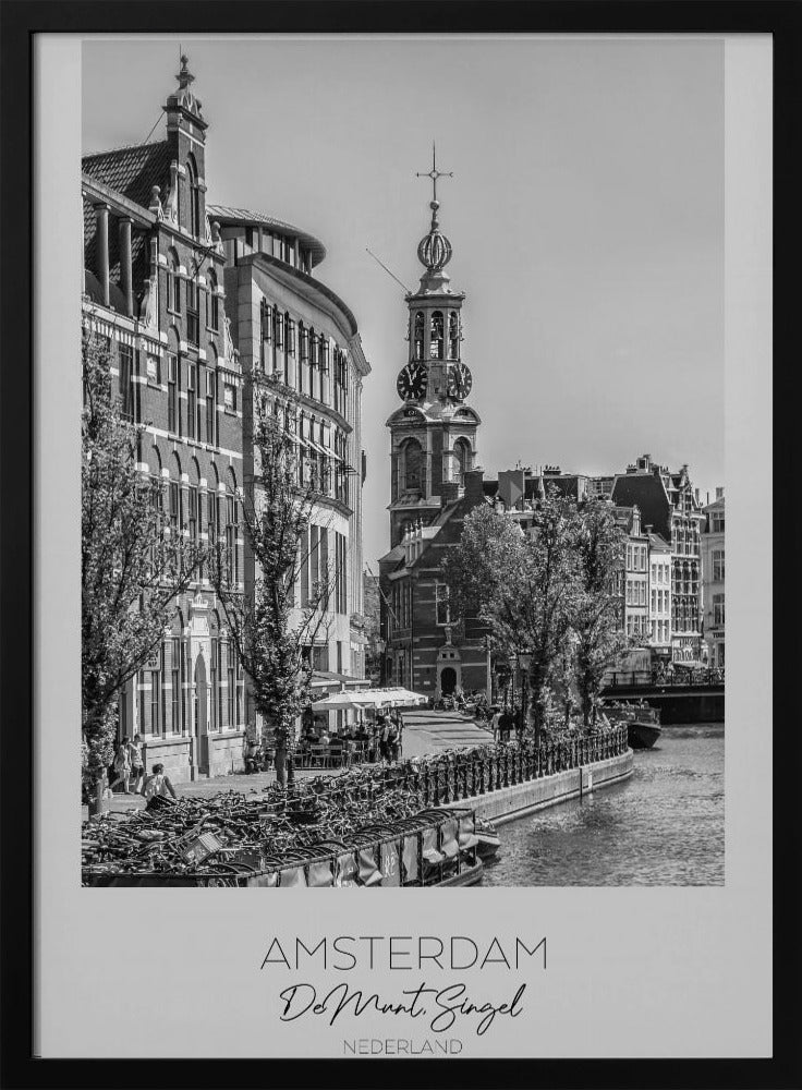 A black and white travel poster of Amsterdam, Netherlands. The photo shows the Munttoren clock tower and traditional Dutch buildings along the Singel canal. A floating barge filled with bicycles is in the foreground. The poster has a white border with the text 'AMSTERDAM', 'De Munt, Singel', and 'NEDERLAND' at the bottom. Artwork