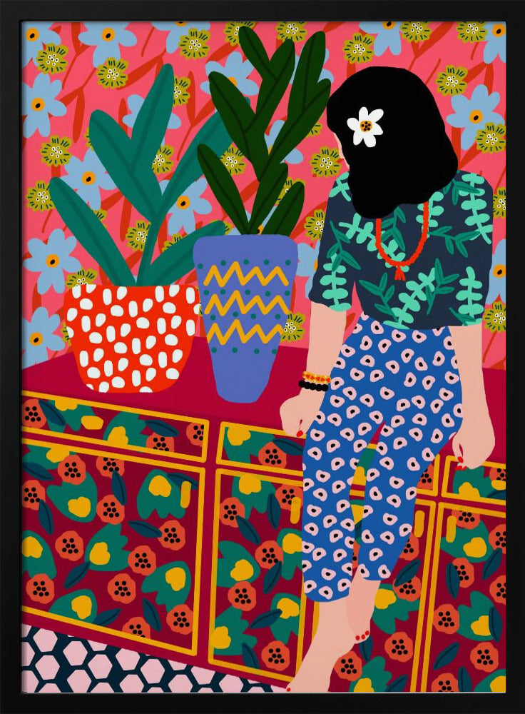 A colorful, maximalist illustration of a woman with black hair and a flower, sitting on a patterned cabinet. She wears a dark blue shirt with green leaves and blue pants with white circles. Next to her are two potted plants in brightly patterned pots, set against a pink and blue floral wallpaper. Poster