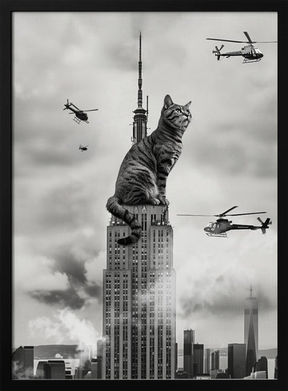 A surreal black and white image depicting a giant tabby cat sitting on top of the Empire State Building, similar to King Kong. Helicopters fly around the colossal cat against a cloudy New York City skyline. Decor