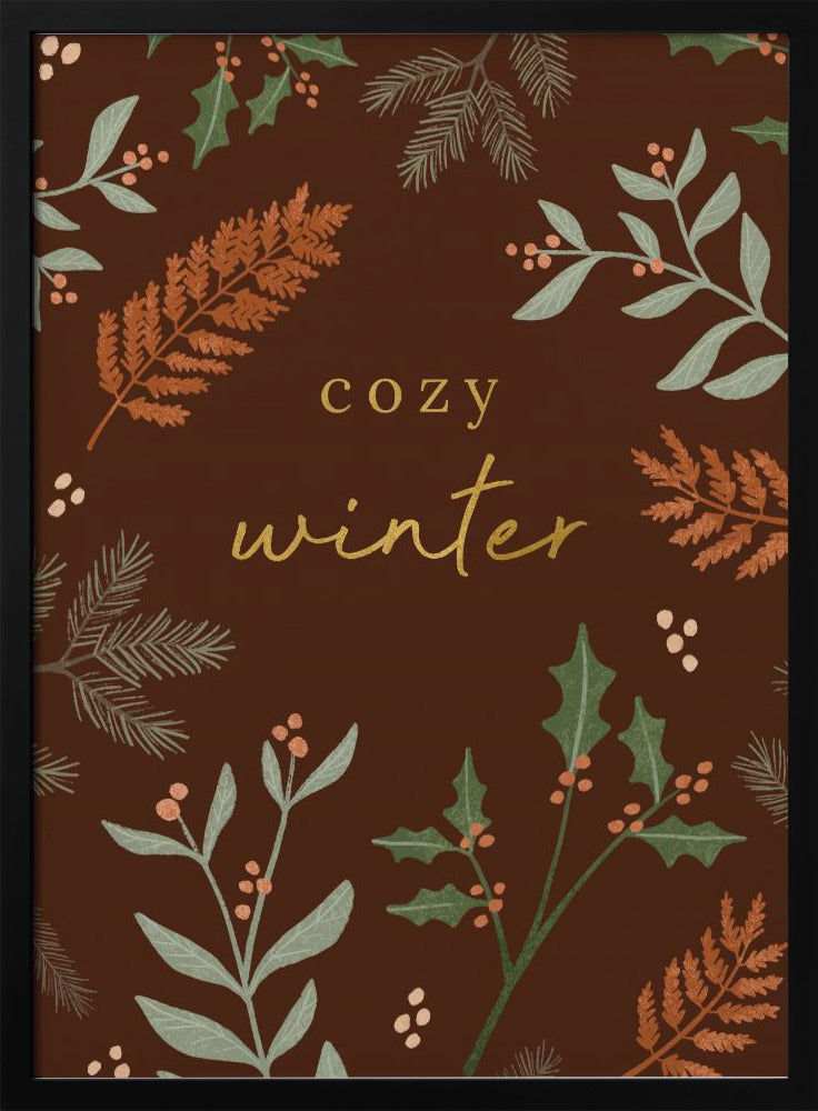 A warm, illustrative poster with a dark brown background featuring the words 'cozy winter' in gold script at the center. The text is framed by a wreath of winter botanicals, including holly, pine needles, and ferns in shades of green and burnt orange. Print