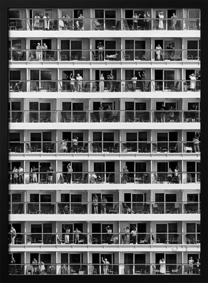 A black and white, high-contrast photograph of the side of a cruise ship, showing a grid of balconies across multiple decks. Various passengers are visible on their balconies, some waving, some relaxing, and some observing, creating a pattern of individual human stories within the repetitive architectural structure. Poster