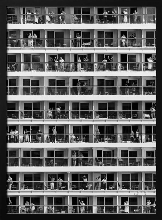 A black and white, high-contrast photograph of the side of a cruise ship, showing a grid of balconies across multiple decks. Various passengers are visible on their balconies, some waving, some relaxing, and some observing, creating a pattern of individual human stories within the repetitive architectural structure. Poster