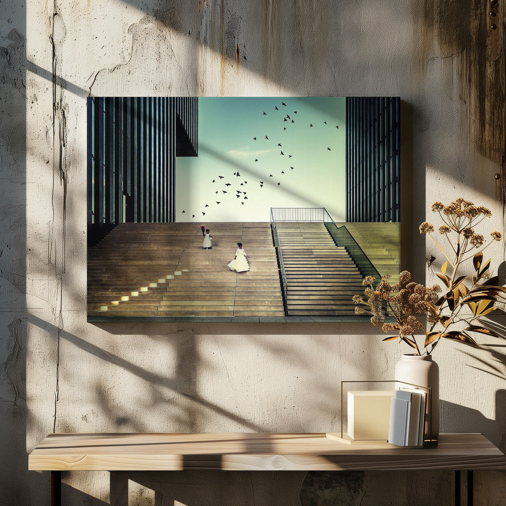 A framed piece of art depicting two young girls in white dresses climbing a vast, modern concrete staircase flanked by two towering, dark buildings. A large flock of birds flies through the teal sky above them, adding a sense of movement to the structured, architectural scene. Poster