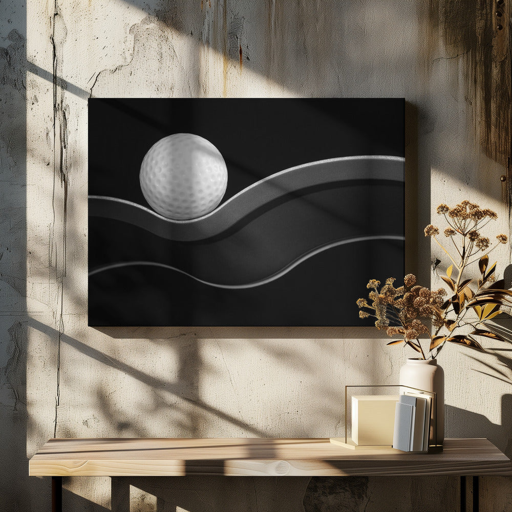 A framed, minimalist black and white photograph of a golf ball resting on a gracefully curving gray surface against a solid black background. Wall Art