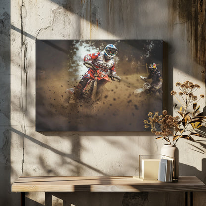 An action shot of a motocross rider in red, white, and blue gear, speeding through a dusty turn on a dirt track, kicking up a large cloud of mud and debris. Another racer is visible in the background. The image is presented within a silver frame. Print