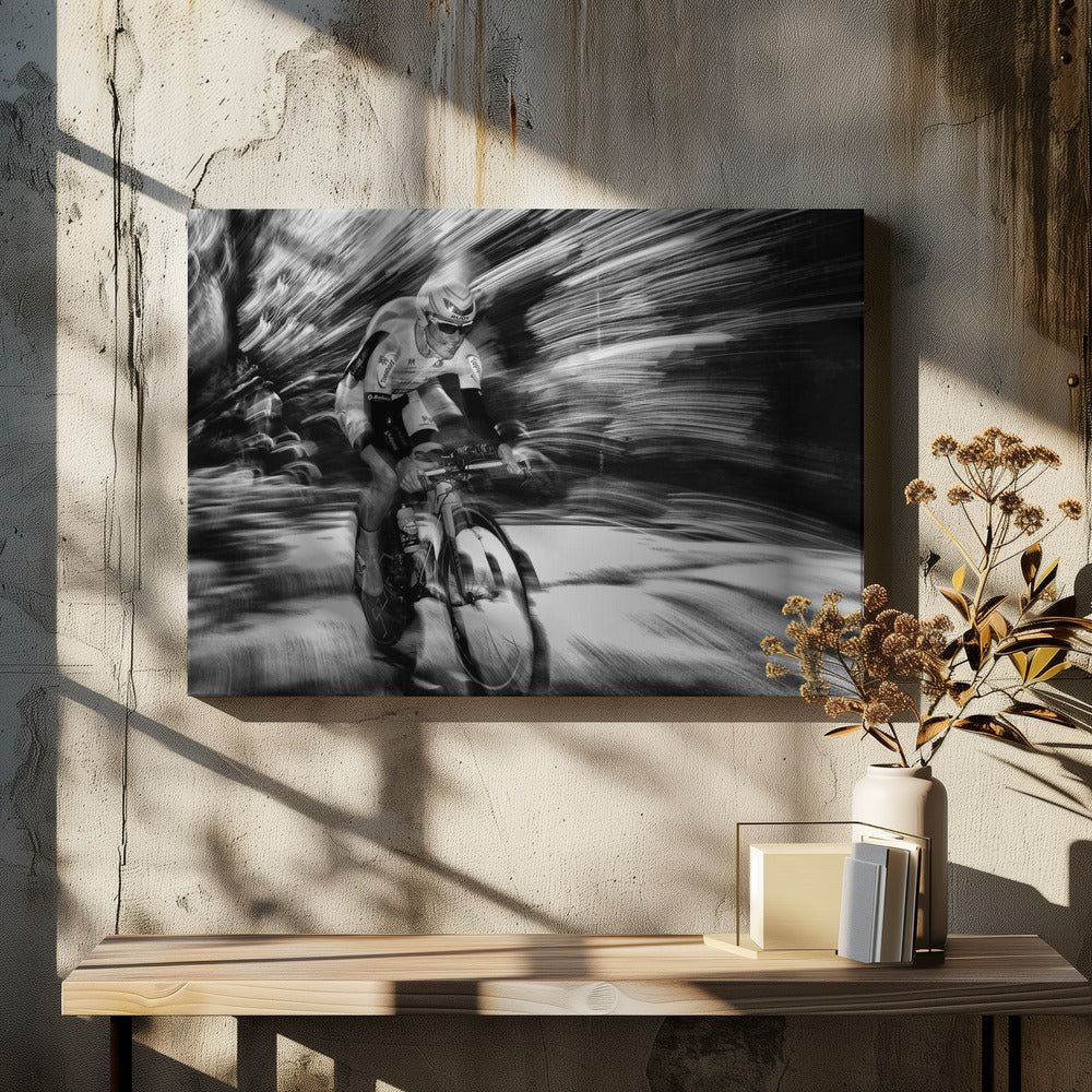 A dramatic black and white action shot of a professional cyclist racing. The cyclist is in focus, wearing a helmet and sunglasses, while the background is a streaky motion blur, creating a powerful sense of speed and movement. The image is enclosed in a silver frame. Wall Art