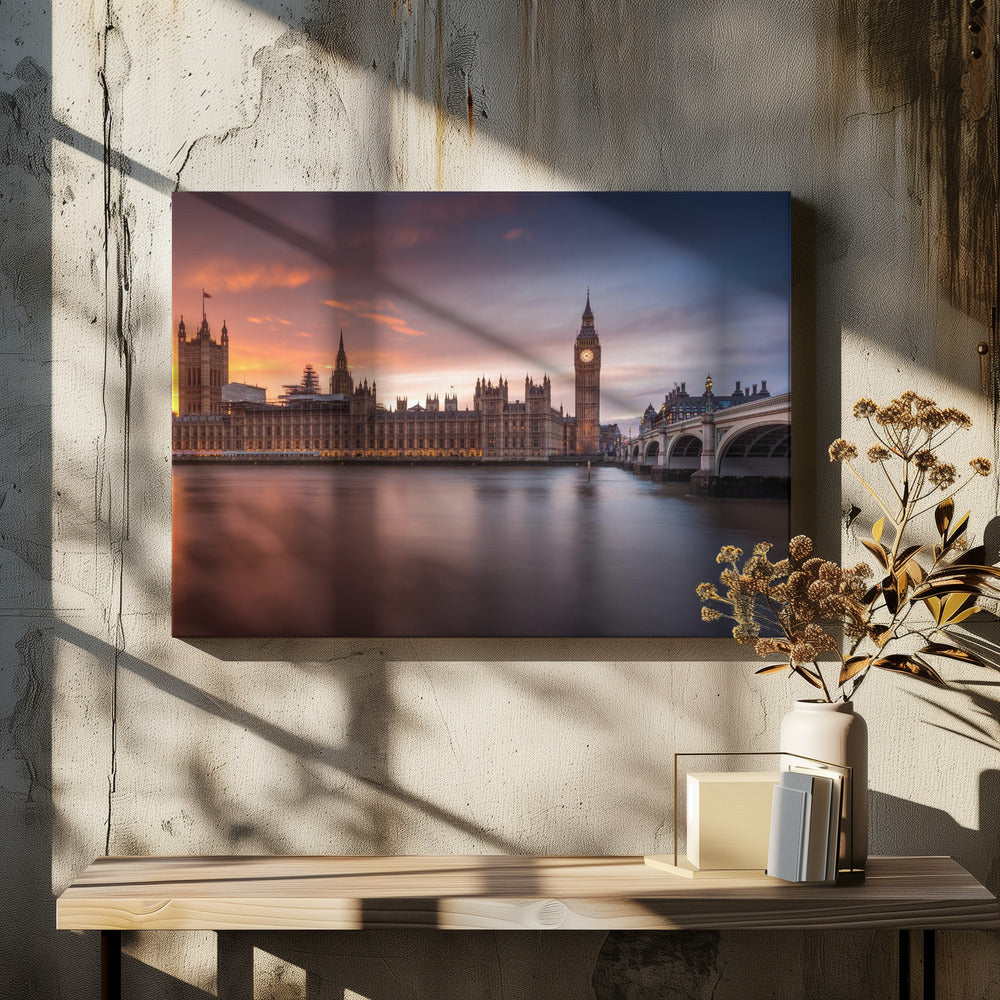 A framed photograph of the Houses of Parliament and Big Ben in London at sunset, with a dramatic orange and purple sky reflecting in the calm waters of the River Thames. Artwork
