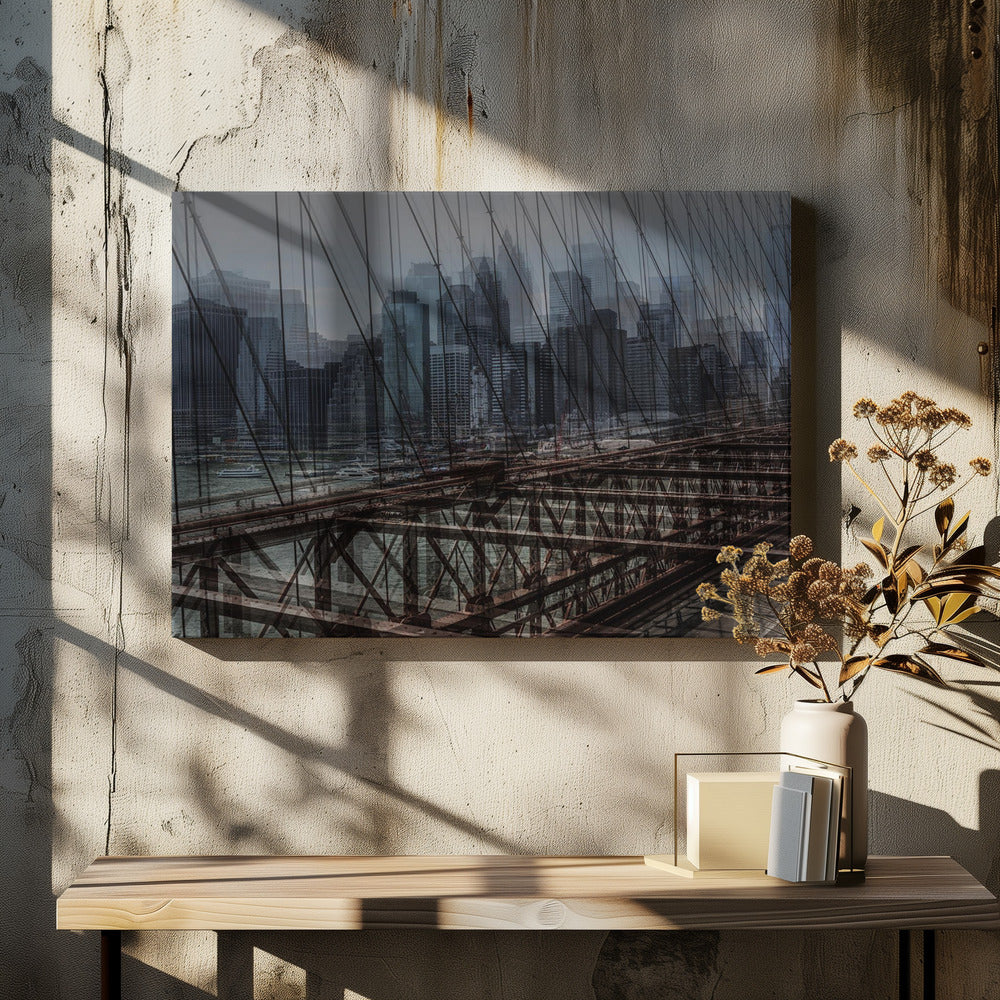 A framed, stylized photograph showing a double exposure of the New York City skyline and the intricate steel structure and cables of the Brooklyn Bridge, creating a dense, layered urban scene with a cool, moody color palette. Decor