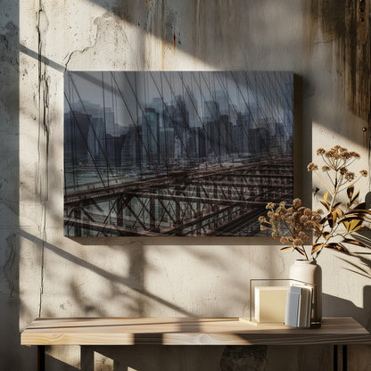 A framed, stylized photograph showing a double exposure of the New York City skyline and the intricate steel structure and cables of the Brooklyn Bridge, creating a dense, layered urban scene with a cool, moody color palette. Decor