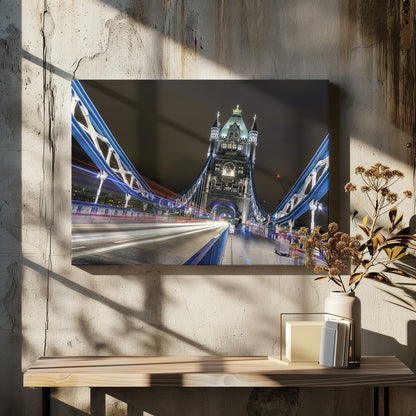 A dramatic, long-exposure night photograph from the deck of London's Tower Bridge, showing vibrant blue support structures curving towards an illuminated stone tower against a dark sky, with bright streaks of light from traffic. Wall Art