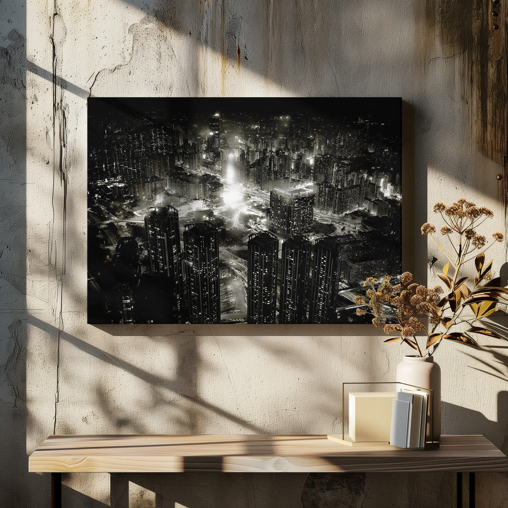 A framed black and white aerial photograph of a dense city at night. The high-angle view captures countless illuminated skyscrapers and winding highways, creating a dramatic and bustling urban landscape. Print