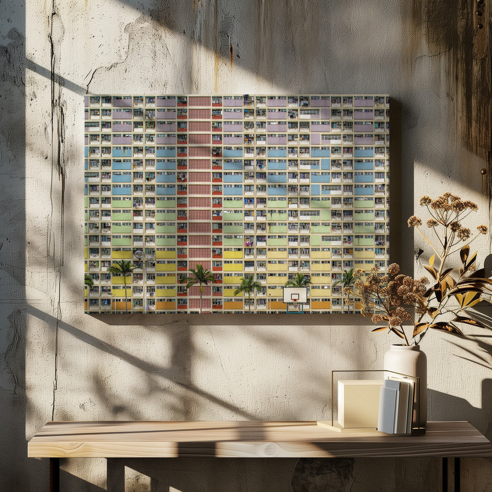 A symmetrical, frontal photograph of the colorful Choi Hung Estate in Hong Kong, featuring a massive grid of apartments with balconies painted in a rainbow of pastel colors including purple, blue, green, yellow, and orange. Palm trees and a basketball court are visible at the base of the building, which is enclosed in a silver frame. Wall Art