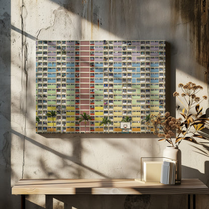 A symmetrical, frontal photograph of the colorful Choi Hung Estate in Hong Kong, featuring a massive grid of apartments with balconies painted in a rainbow of pastel colors including purple, blue, green, yellow, and orange. Palm trees and a basketball court are visible at the base of the building, which is enclosed in a silver frame. Wall Art