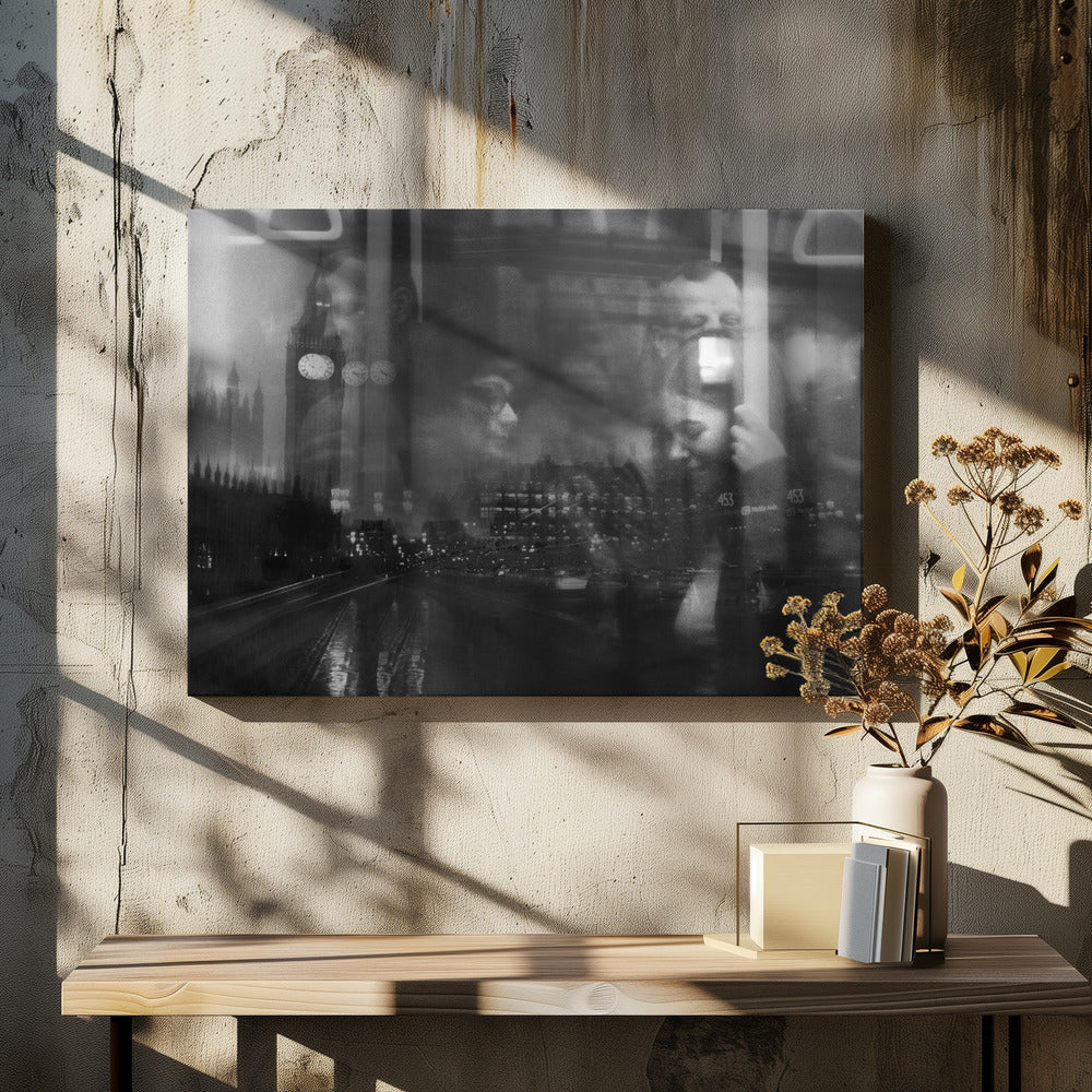 A moody black and white double exposure photograph showing a rainy London street at night with Big Ben, overlaid with the faint reflections of people inside a moving vehicle like a bus. The image has a dreamy, layered effect and is displayed in a silver frame. Print