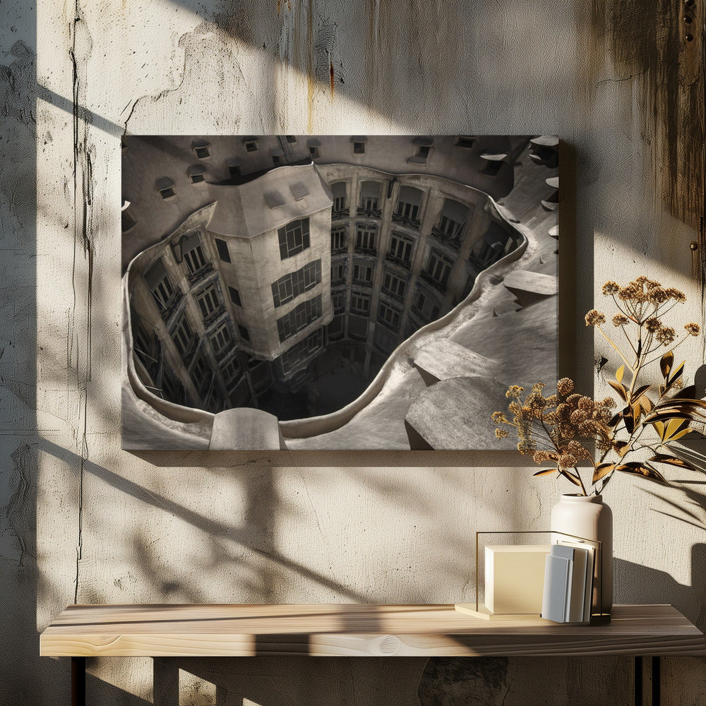 A surreal, high-angle photograph looking down into the distorted, cavernous courtyard of a building. The walls and windows appear to melt and curve inwards towards a dark void, creating a powerful optical illusion. The image has a muted, sepia-toned color palette and is presented in a silver frame. Wall Art