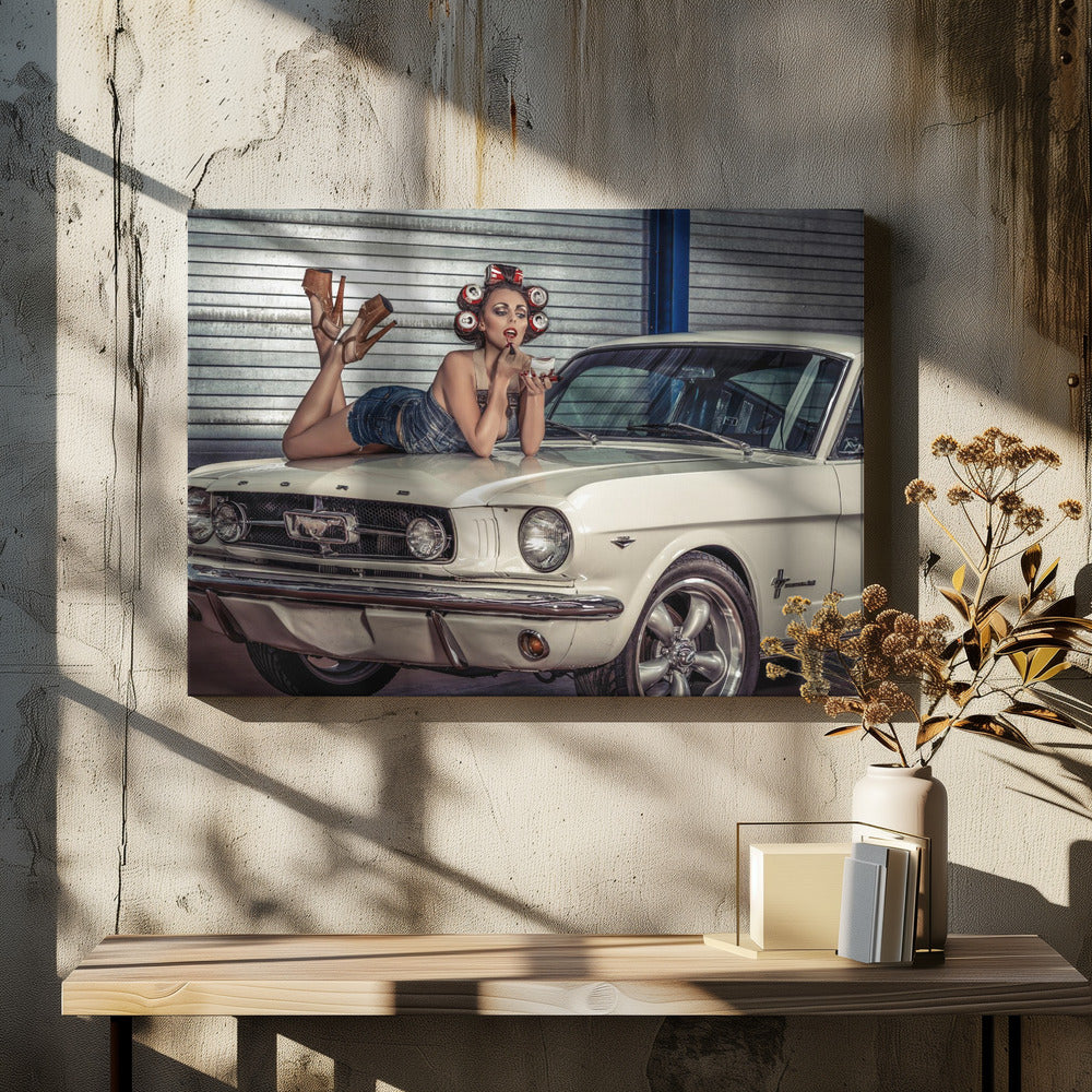 A woman in a retro pin-up style lies on the hood of a vintage white Ford Mustang in a garage, applying red lipstick with her hair set in soda can curlers. Poster