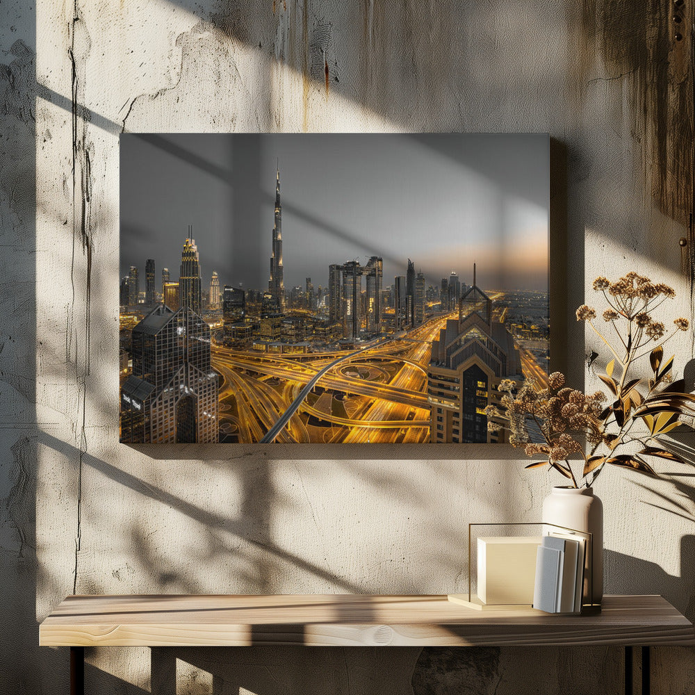 A framed, high-angle, long-exposure photograph of the Dubai skyline at dusk. The towering Burj Khalifa stands out against a grey sky, while the city's skyscrapers are illuminated. In the foreground, a complex network of highways glows with the yellow light trails of traffic, creating intricate patterns. Poster