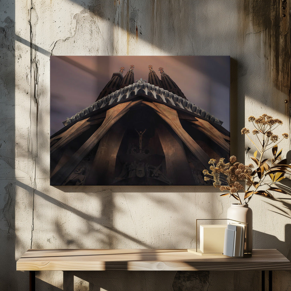 A dramatic, low-angle shot of the Sagrada Familia cathedral, focusing on the intricate details of the Passion Facade against a dusky purple and orange sky. The spires tower above, while deep shadows highlight the unique, angled columns and the central sculpture of the crucifixion. Poster
