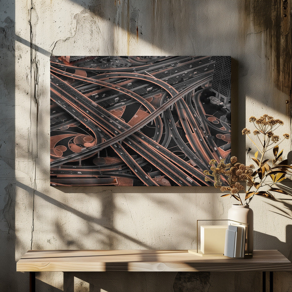 A framed aerial photograph of a sprawling, multi-level highway interchange presented in a selective color style. Dark grey roads weave over and under each other, while the surrounding land is a contrasting copper-brown, creating a dramatic and complex urban pattern. Poster