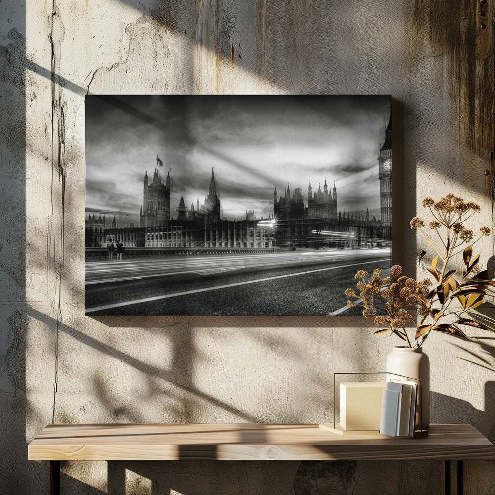 A framed, black and white long-exposure photograph of the Houses of Parliament and Big Ben in London. The view is from a bridge, with streaks of white light from traffic blurring across the road in the foreground under a dramatic, cloudy sky. Wall Art