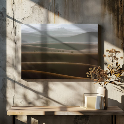 A framed photograph of a serene desert landscape, with layers of rolling sand dunes creating a sense of depth. Dark brown dunes in the foreground give way to lighter, hazy dunes and hills in the misty background. Print