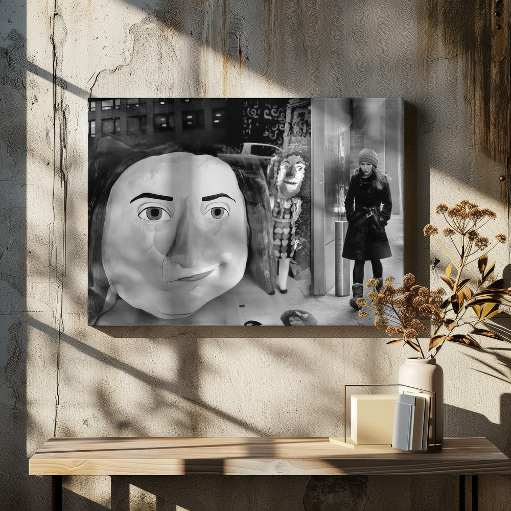 A surreal black and white photograph with a silver frame, featuring a giant, cartoonish head of a historical figure reflected in a window, juxtaposed with a young woman in a winter coat and beanie walking down a city sidewalk. Wall Art