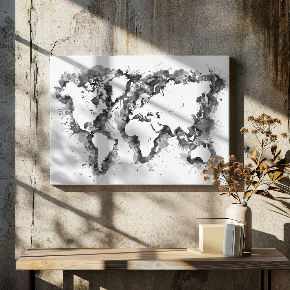 An abstract black and white world map created with ink splatters and watercolor washes on a white background, enclosed in a silver frame. The continents are formed by the negative space, outlined by the dynamic splatters of black and grey ink. Print