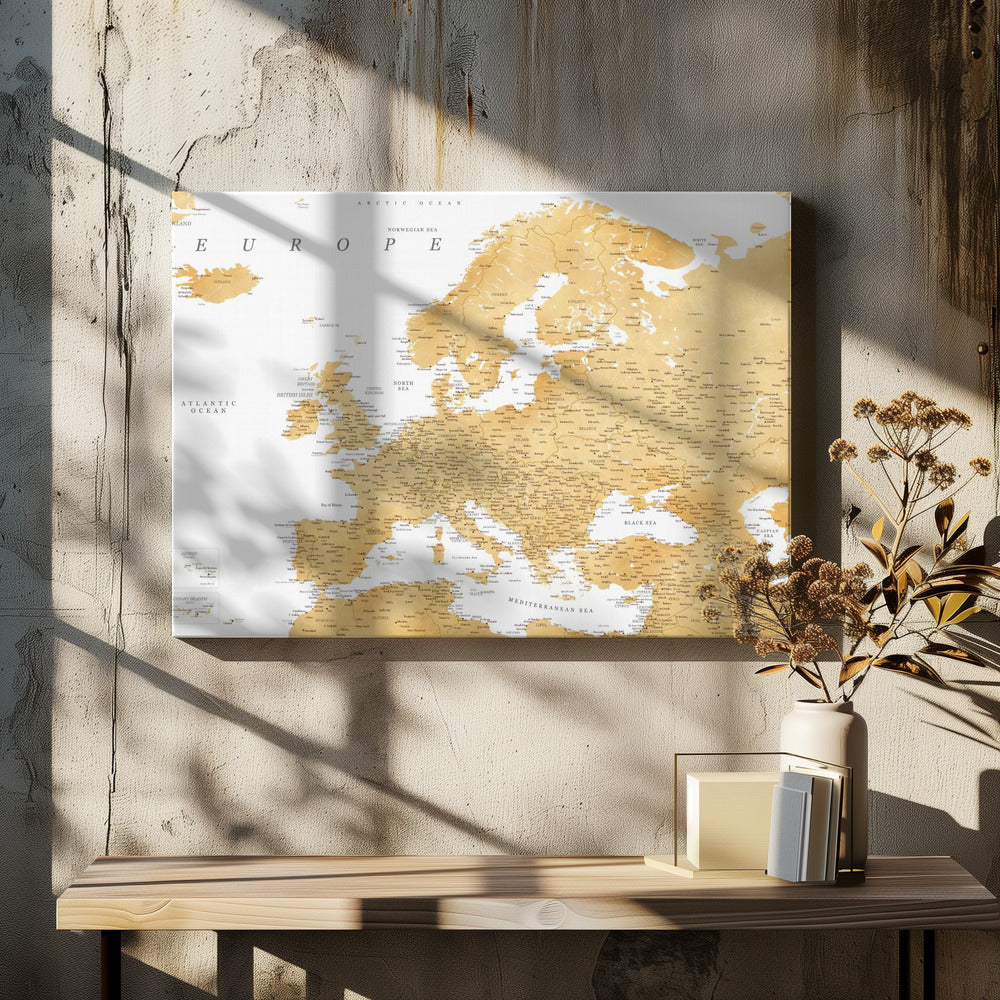 A framed map of Europe featuring golden landmasses on a crisp white background. The map includes country names, major cities, and bodies of water, all presented in a clean, modern font. The artwork is enclosed in a simple, light gray frame. Print