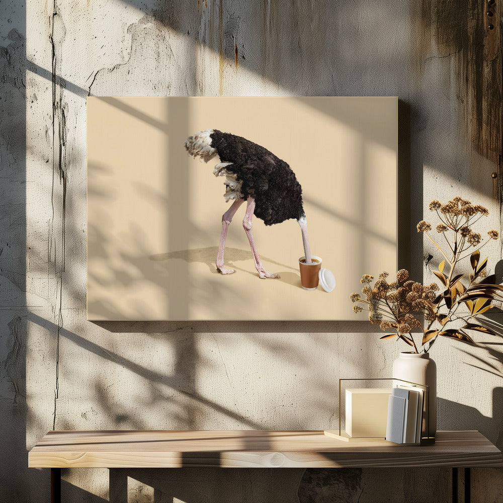 A humorous and surreal image of a black and white ostrich with its head buried inside a disposable coffee cup, set against a plain beige background and enclosed in a silver frame. Decor