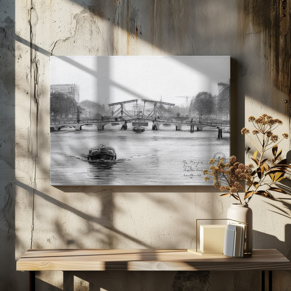 A framed black and white pencil drawing of the Magere Brug, a famous bridge in Amsterdam. The drawbridge is depicted over a canal with a boat in the foreground, creating a classic European city scene. Wall Art