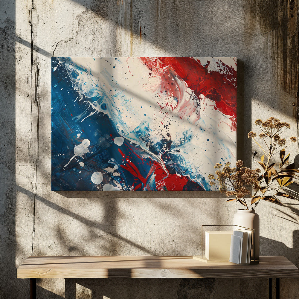 A close-up of an abstract painting in a silver frame, featuring a dynamic composition of red, white, and blue. Thick strokes of paint are splattered and swirled across the canvas, with a large area of deep blue on the left, a bold patch of bright red on the upper right, and a field of off-white in the middle. The piece has a textured, energetic quality. Artwork