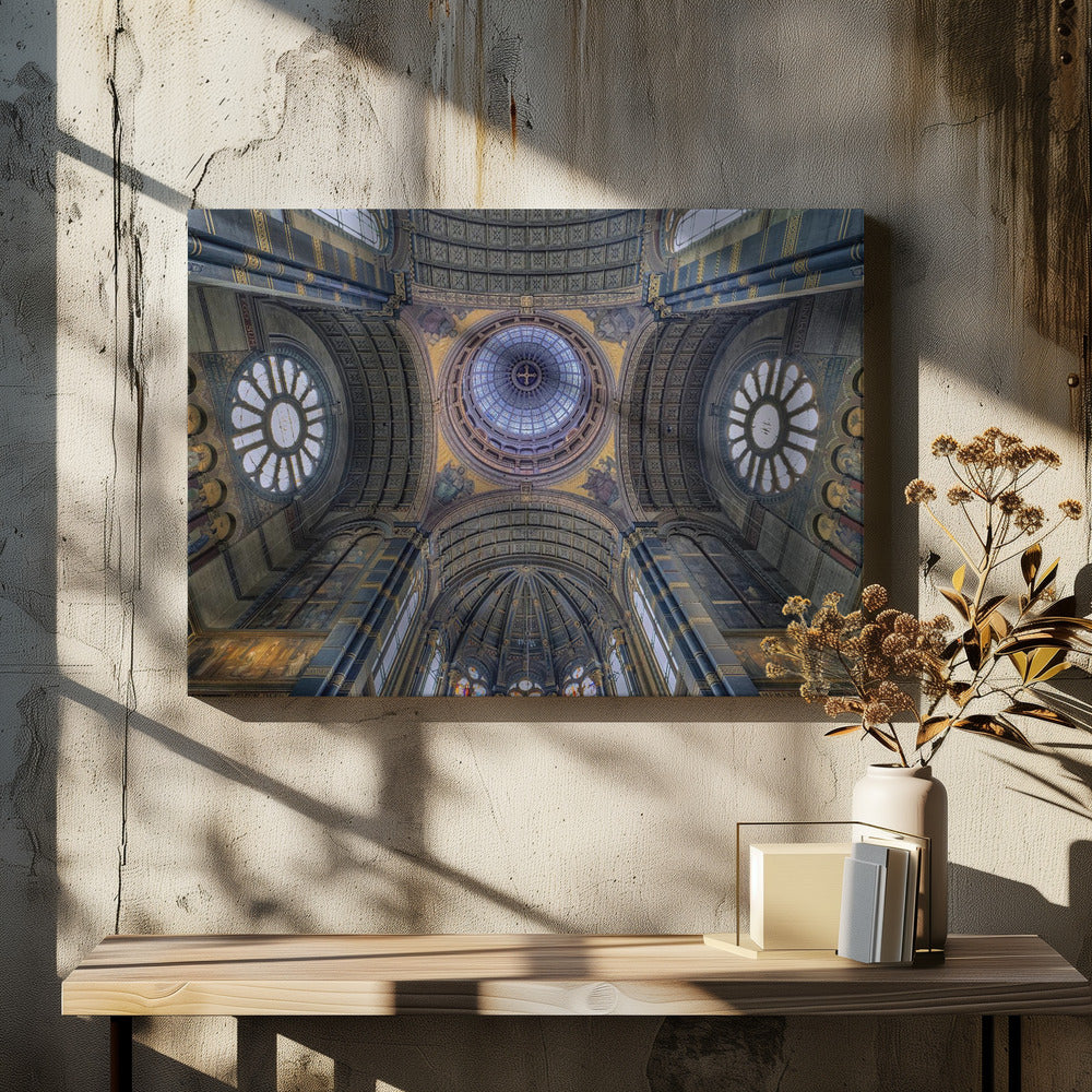 An upward-looking view of the highly ornate vaulted ceiling of a grand cathedral, featuring a central glass dome, large rose windows, and intricate gold and blue details, all framed in silver. Poster