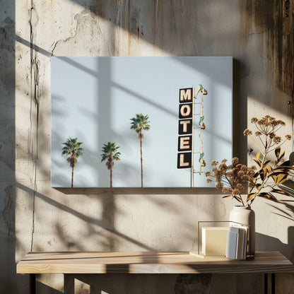 A minimalist photograph featuring three tall palm trees and a vertical black and white 'MOTEL' sign against a pale blue sky. Affixed to the sign's pole are several figures of women in green swimsuits, posed as if diving in a synchronized formation. Poster