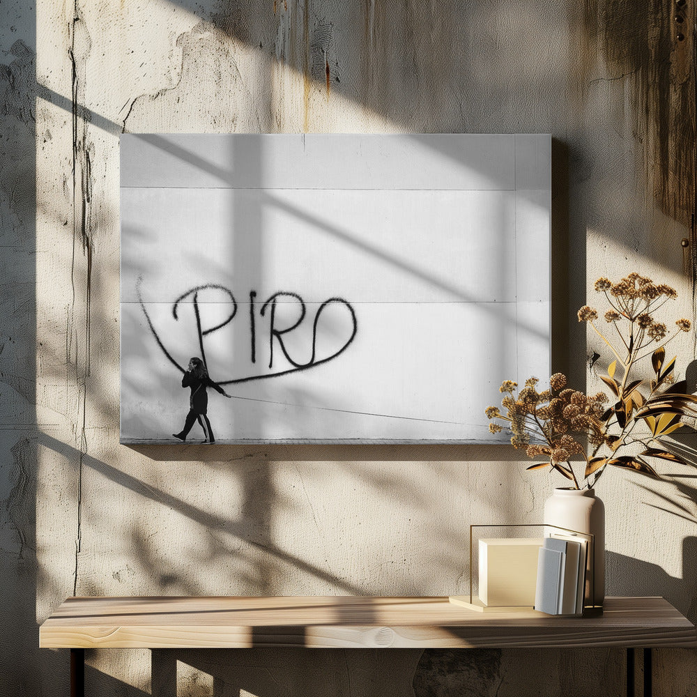 A minimalist black and white photograph of a woman dressed in black walking a small, fluffy white dog on a long leash. They are walking along a sidewalk in front of a large, pale wall with the word 'PIRO' written in black spray paint graffiti. The entire image is enclosed in a light grey frame. Poster