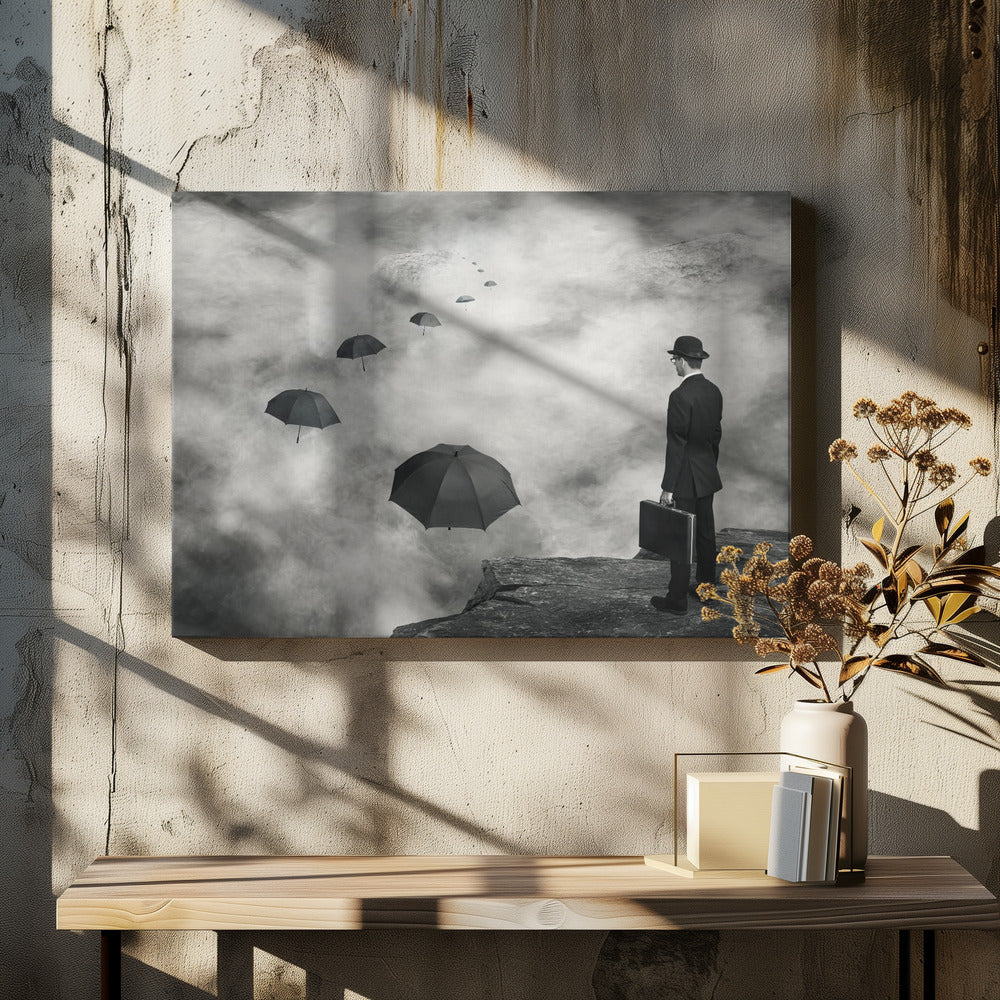 A surreal black and white photograph of a man in a suit and bowler hat holding a briefcase, standing on a cliff edge. He gazes into a foggy expanse where a path of floating black umbrellas leads into the misty distance. Decor